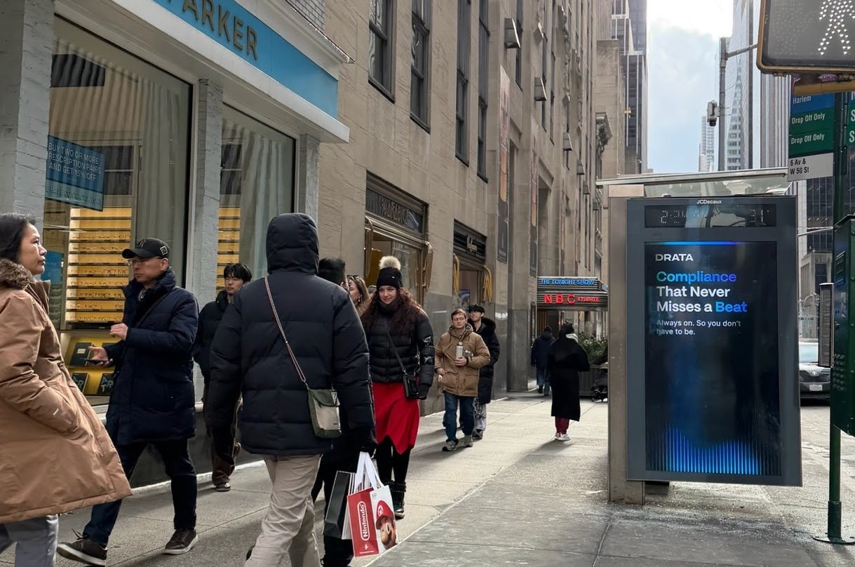 Drata 'Compliance That Never Misses a Beat' bus shelter near NBC Studios, Midtown Manhattan