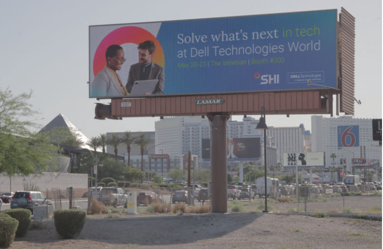 Large-format roadside billboard along the corridor between airport and conference venue.